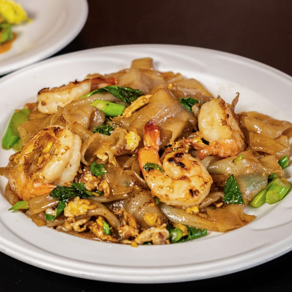 Close-up of Lily Thai's Pad See Ew with shrimp, wide noodles, egg, and green vegetables.